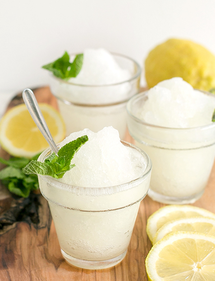 three glasses with lemon granita, topped with mint leaves