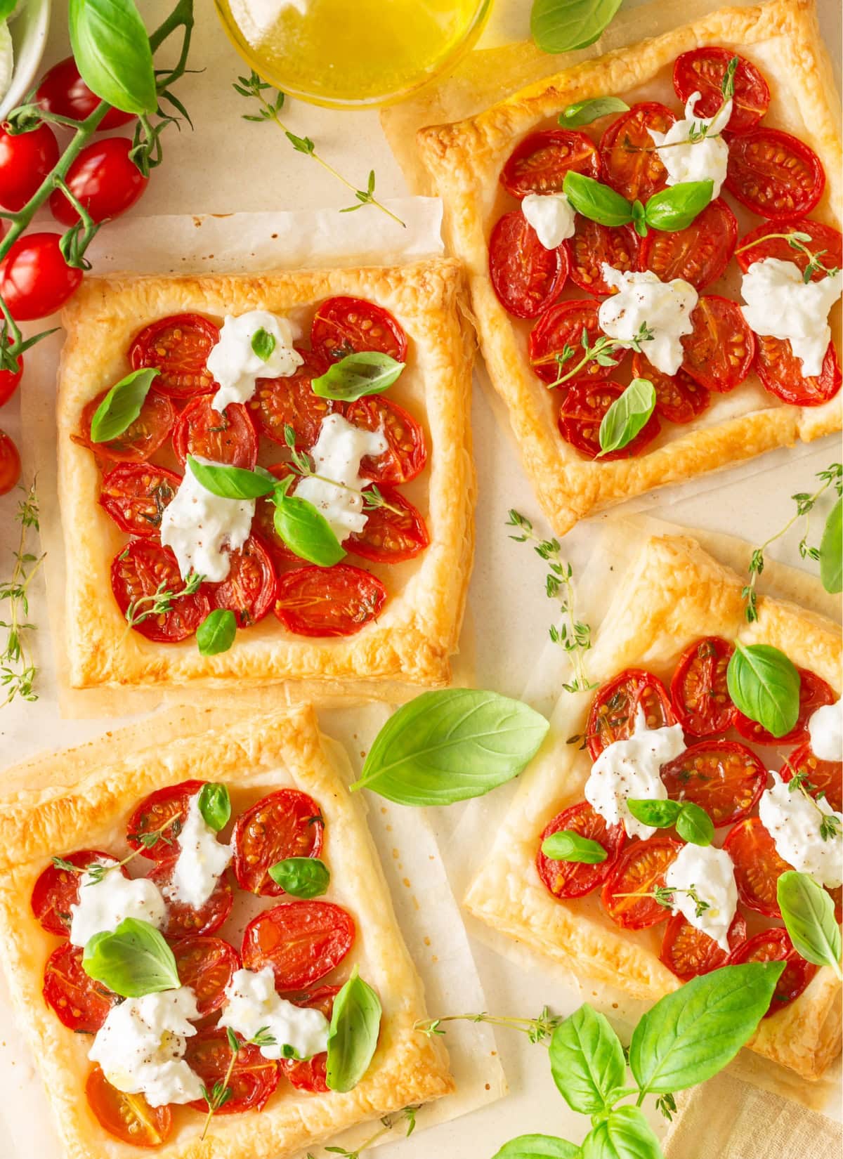 Caprese puff pastry with tomatoes, burrata cheese and basil leaves.