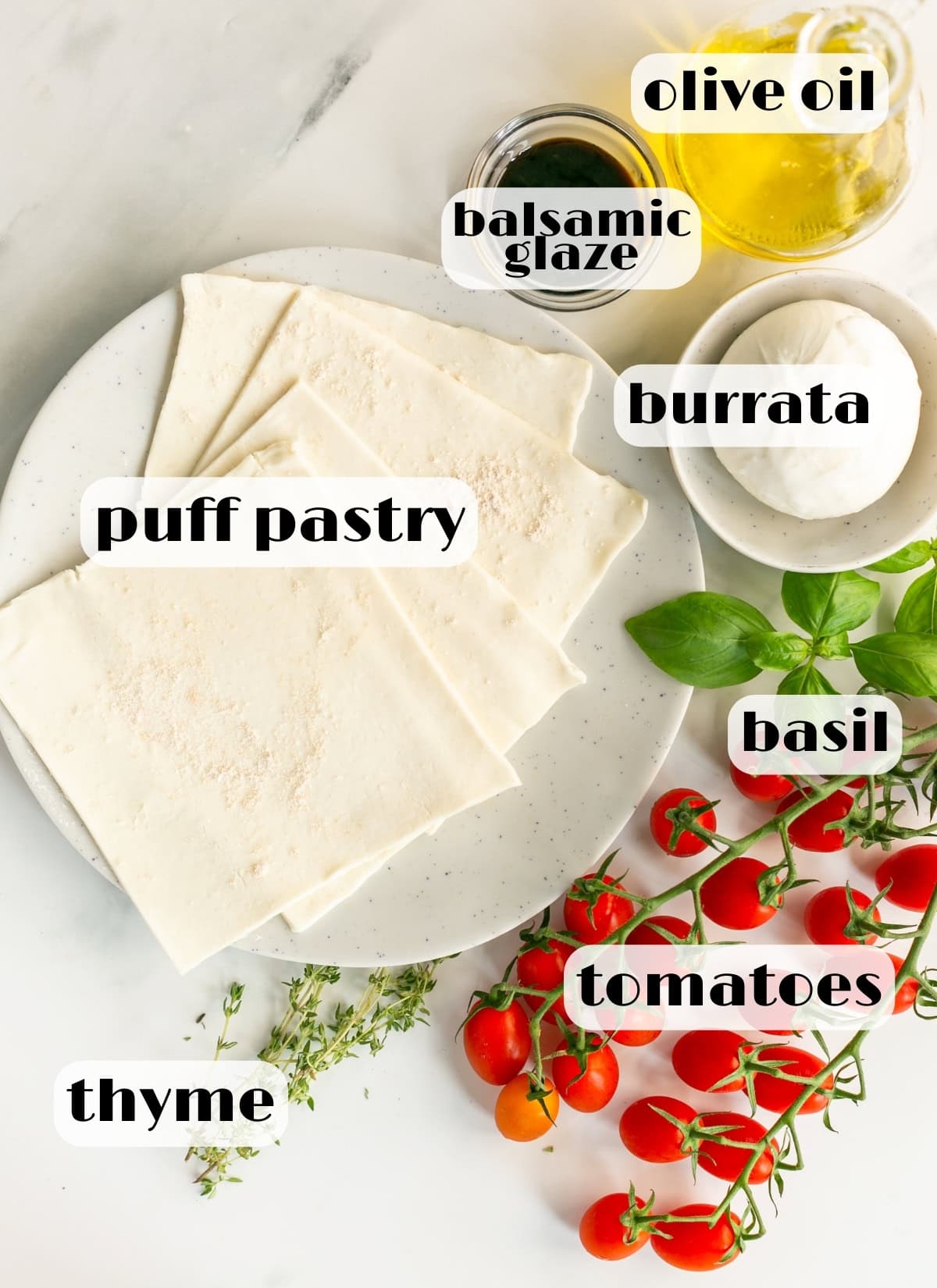 caprese tarts ingredients: puff pastry. tomatoes, basil, thyme, olive oil, balsamic glaze, burrata cheese.