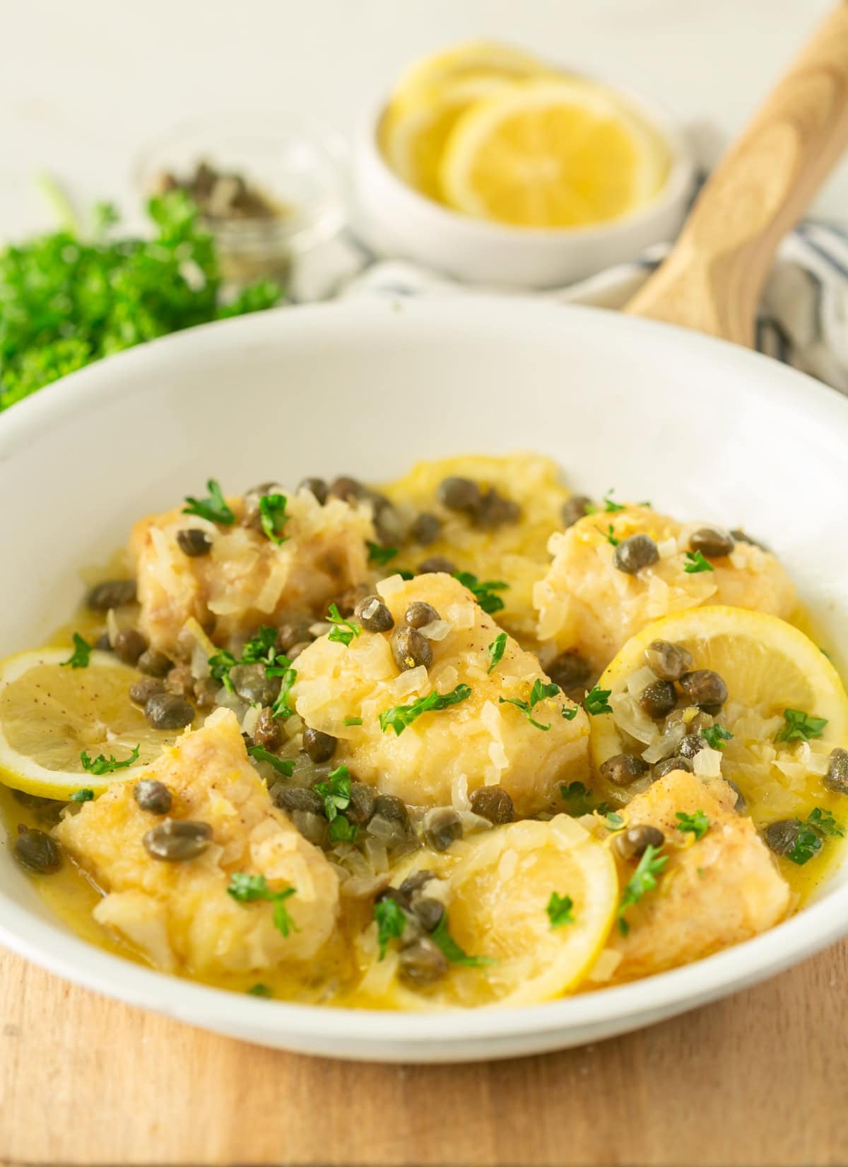 fish piccata topped with parsley lemon and capers.