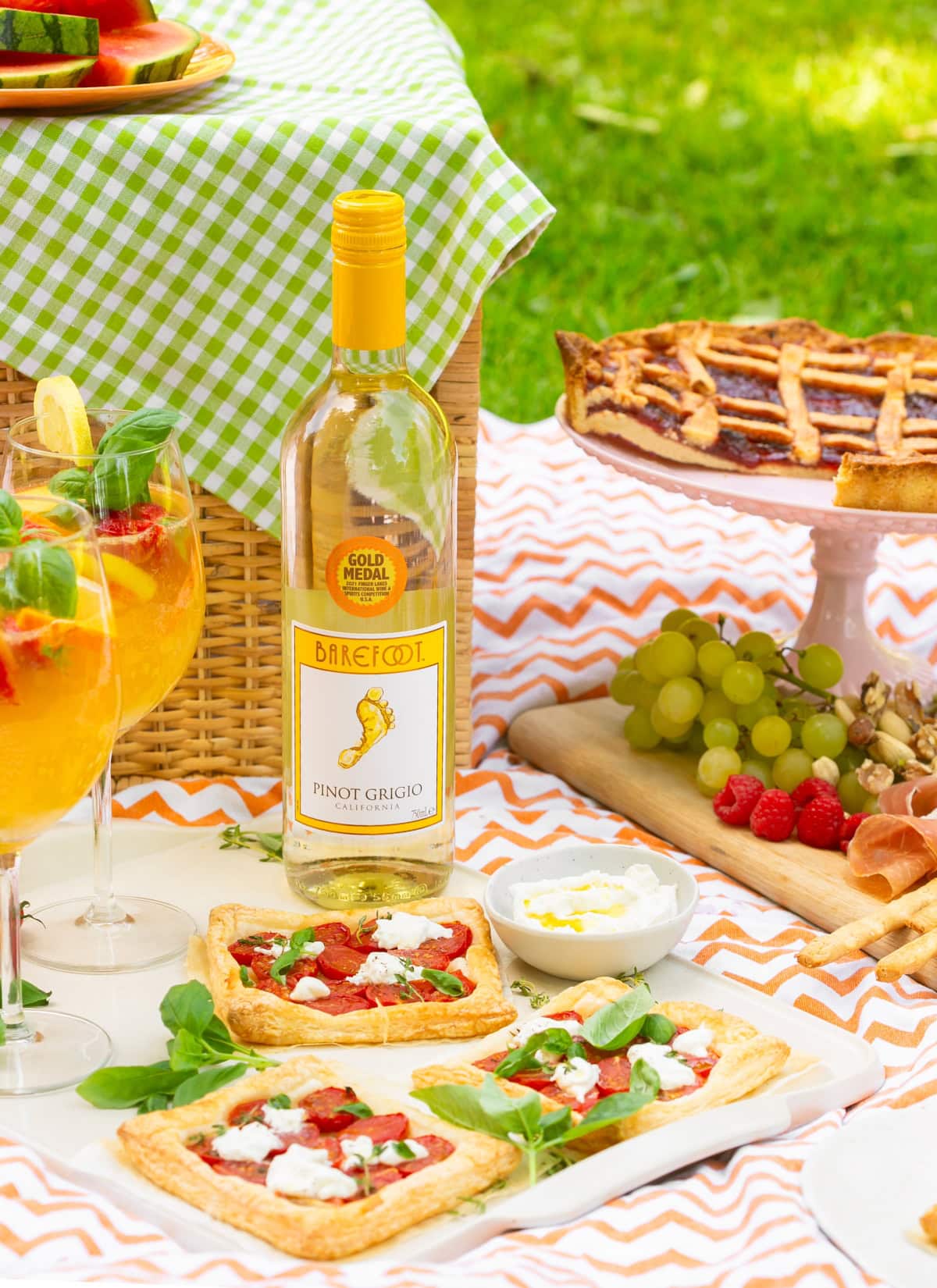 White sangria served in wine glasses in a picnic setting.