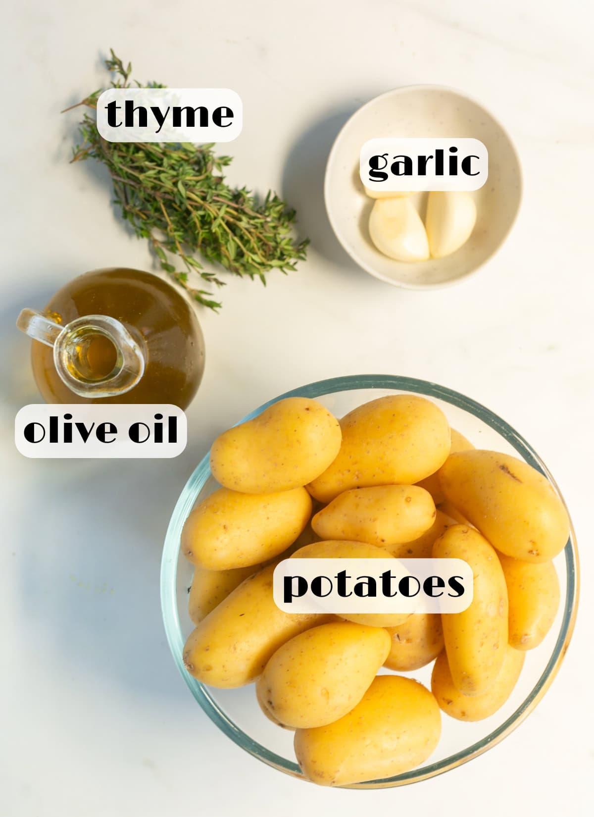 ingredients for confit potatoes: potatoes, thyme, garlic, olive oil.